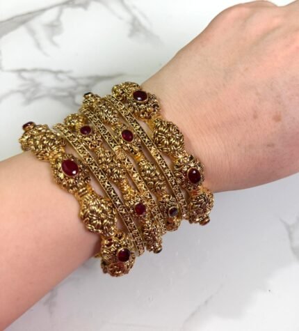 Premium gold-plated bangle set with a timeless and classy design, elegantly displayed on a woman’s wrist.