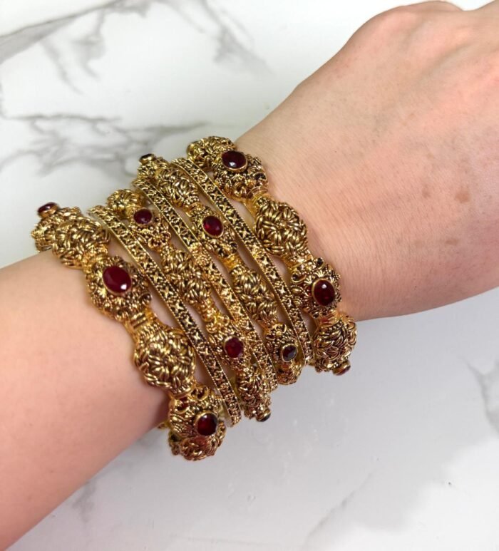 Premium gold-plated bangle set with a timeless and classy design, elegantly displayed on a woman’s wrist.