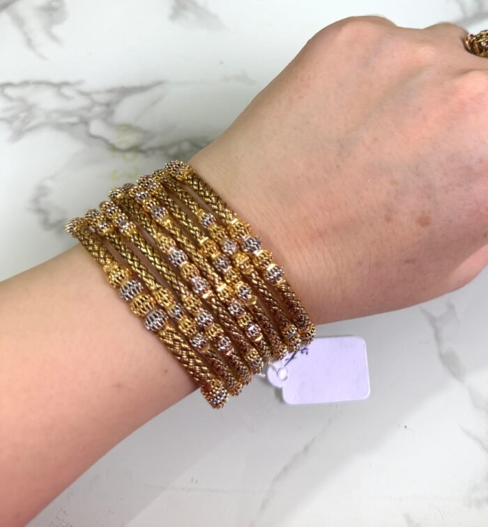 Material: Durable gold-plated alloy Design: Intricate floral patterns with traditional elegance Finish: High-polish gold tone for a radiant shine Style: Ideal for festive events, cultural occasions, and daily ethnic wear Set Includes: Multiple bangles designed in a coordinated floral theme