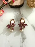 Gold loop earrings adorned with pink crystals, floral motif, and a pearl drop.