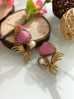 Gold-toned earrings with pink triangular stones, pearl drops, and leaf-inspired golden branch design.