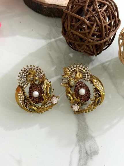 Antique gold earrings with copper stone center, pearl detail, and leaf-shaped crystal embellishments.