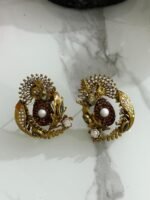 Antique gold earrings with copper stone center, pearl detail, and leaf-shaped crystal embellishments.