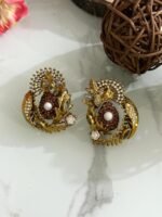 Antique gold earrings with copper stone center, pearl detail, and leaf-shaped crystal embellishments.