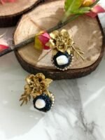 Gold floral stud earrings with navy blue crystal circle and central pearl, accented with a golden leaf.