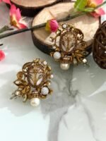 Ornate antique gold earrings with floral and leaf design, white stones, and hanging pearl drop.