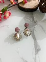 Ornate antique gold earrings with floral and leaf design, white stones, and hanging pearl drop.