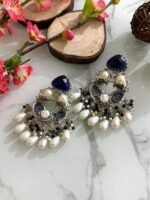 Silver chandbali earrings with navy blue crystal tops, pearl clusters, and intricate silver detailing, adorned with pearl and navy bead drops.