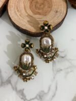 Step into elegance with these Baroque-inspired pearl drop earrings. Featuring a sculpted floral top and ornate golden detailing. Each piece is centered around a lustrous faux pearl with gem-studded accents. Delicate yet bold — perfect for ethnic wear or evening glam. Crafted to capture timeless grace with a garden-fantasy twist.