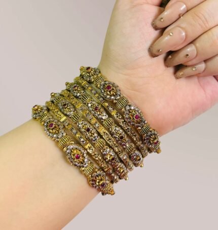 uxury gold-plated bangle set featuring maroon stone embellishments and delicate ball detailing