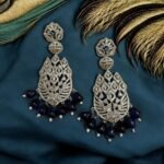 Sparkling diamond-inspired earrings with teardrop pearl accents.