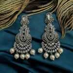 Dazzling crystal earrings with black accents and pearl drops.