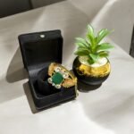 Green stone bracelet with gold-plated floral accents and crystal embellishments.