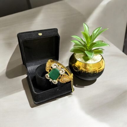 Green stone bracelet with gold-plated floral accents and crystal embellishments.