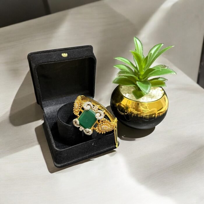 Green stone bracelet with gold-plated floral accents and crystal embellishments.