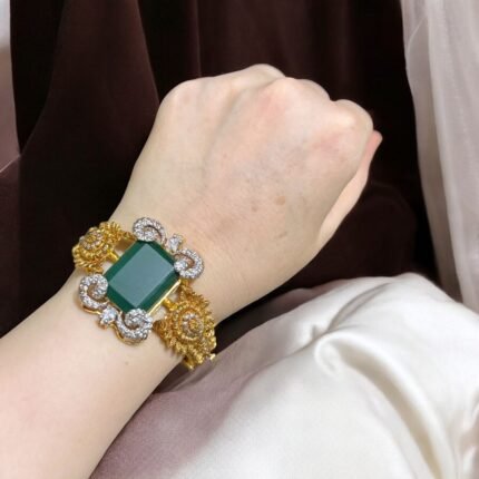 Green stone bracelet with gold-plated floral accents and crystal embellishments.
