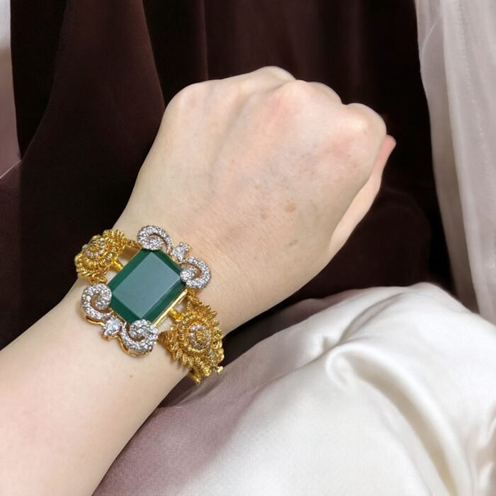 Green stone bracelet with gold-plated floral accents and crystal embellishments.