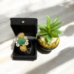 Green stone bracelet with gold-plated floral accents and crystal embellishments.