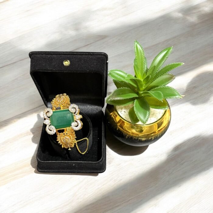 Green stone bracelet with gold-plated floral accents and crystal embellishments.