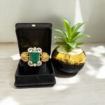 Green stone bracelet with gold-plated floral accents and crystal embellishments.