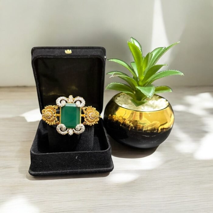 Green stone bracelet with gold-plated floral accents and crystal embellishments.