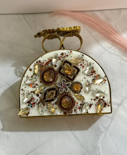 A sophisticated gold clutch with crystal and pearl embellishments, perfect for adding an elegant touch to your formal and evening outfits.