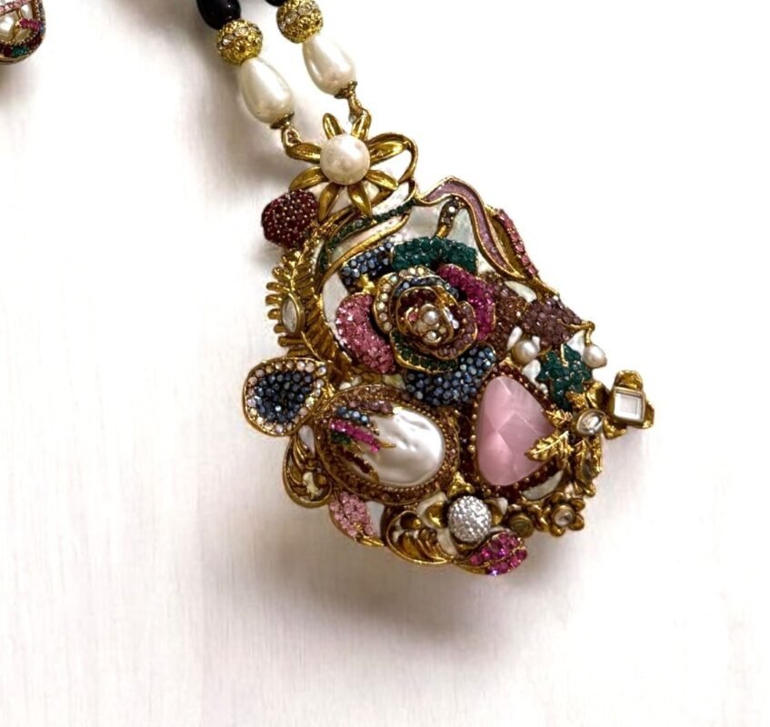 Colorful vintage-style necklace and matching earrings with pearls and crystals, displayed on a light background.