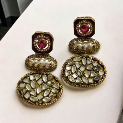 Vintage-style gold earrings with blue and pearl accents, featuring geometric-shaped stones.