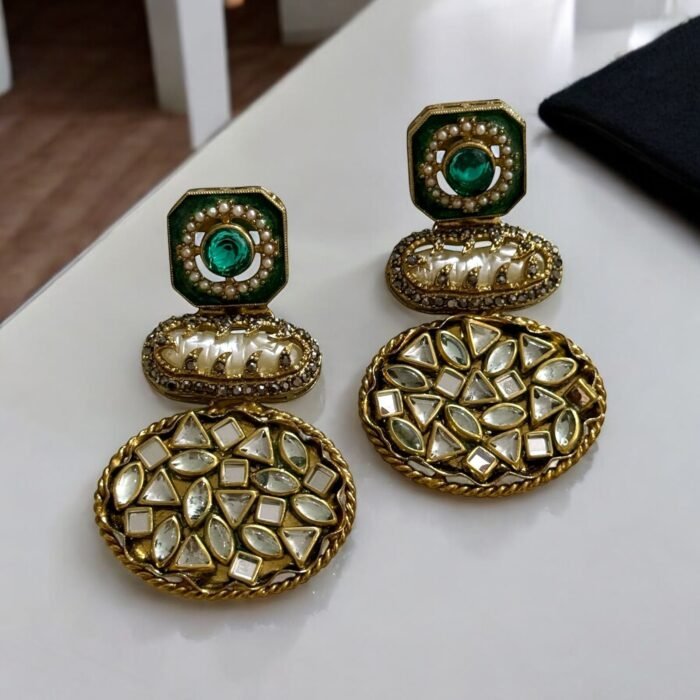 Vintage-style gold earrings with blue and pearl accents, featuring geometric-shaped stones.
