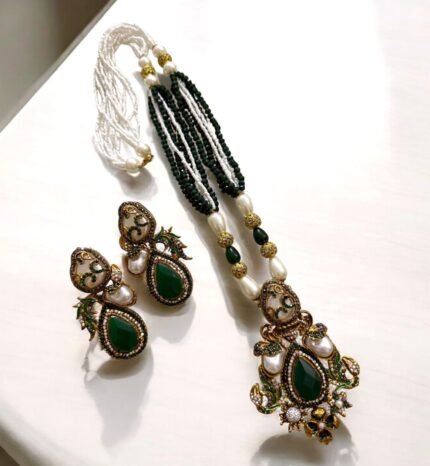Green stone and pearl embellished necklace with matching earrings, featuring intricate gold detailing.