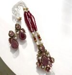 Ruby and pearl embellished necklace set with matching earrings, featuring gold detailing.