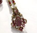 Ruby and pearl embellished necklace set with matching earrings, featuring gold detailing.