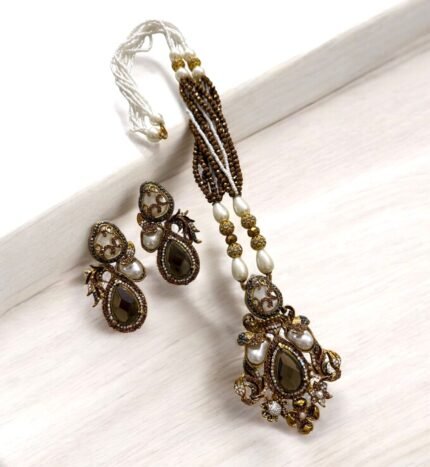 Elegant brown gemstone and pearl necklace set with matching earrings, featuring gold accents.