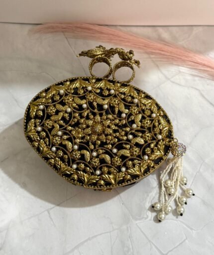 Black and gold floral evening clutch with pearl embellishments and a tassel detail, featuring bird-shaped top handles.