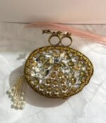 Vintage-inspired evening clutch with clear and gold-toned crystals, pearls, floral design, and a tassel detail.