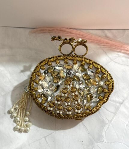 Vintage-inspired evening clutch with clear and gold-toned crystals, pearls, floral design, and a tassel detail.