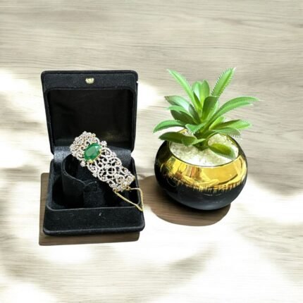 Chic bracelet with a green stone centerpiece and dazzling crystal accents, perfect for adding a luxurious touch to any outfit.