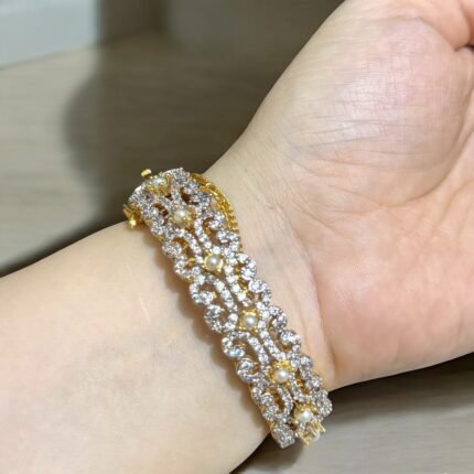 Gold bracelet with pearls and crystal embellishments.