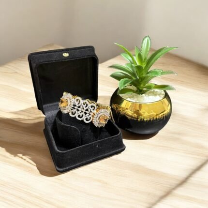 Gold bracelet with citrine stone and crystal embellishments.