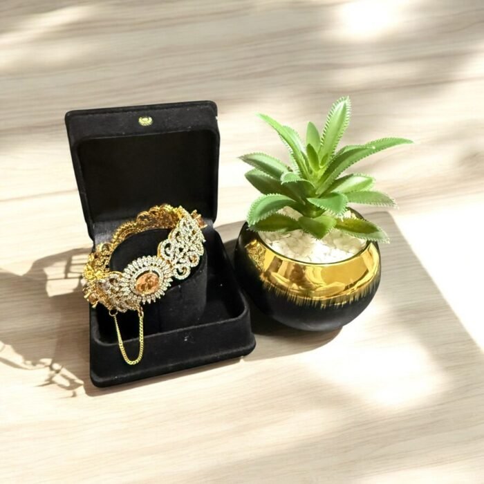Gold bracelet with citrine stone and crystal embellishments.
