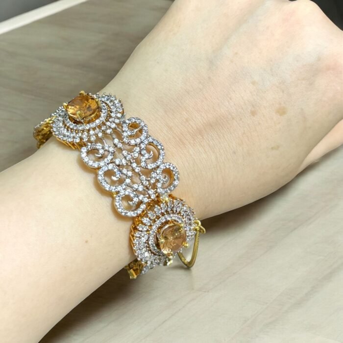Gold bracelet with citrine stone and crystal embellishments.