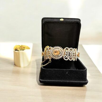 Gold bracelet with citrine stone and crystal embellishments.