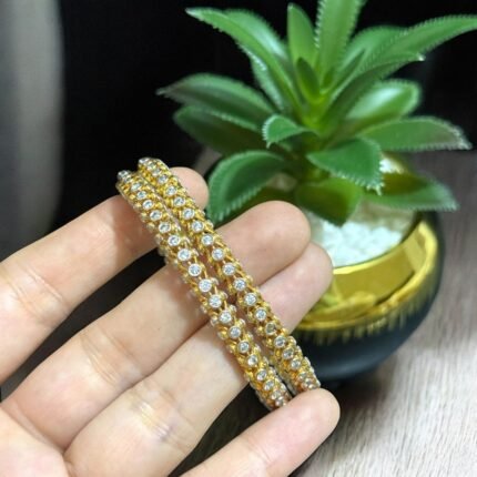 Double-line gold bangle with sparkling crystal embellishments.
