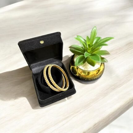 Double-line gold bangle with sparkling crystal embellishments.