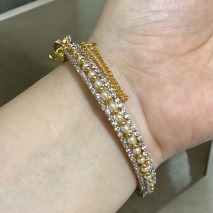 Gold bracelet with pearls and crystal embellishments.