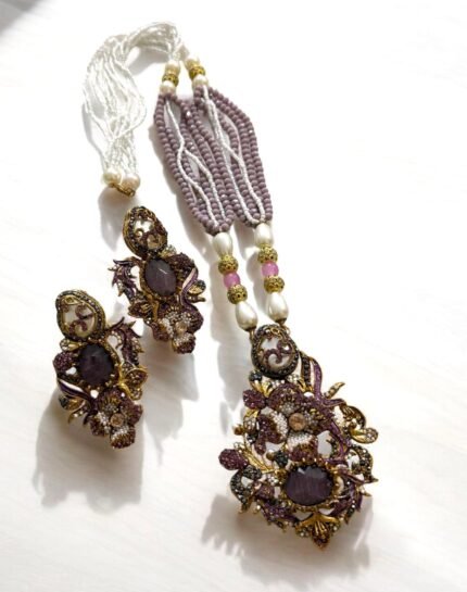 Lavender crystal and pearl necklace with floral pendant, paired with matching earrings.