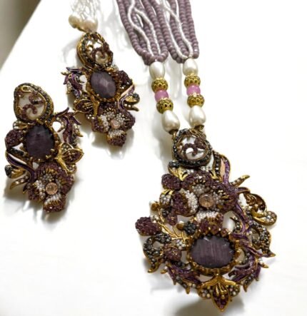 Lavender crystal and pearl necklace with floral pendant, paired with matching earrings.