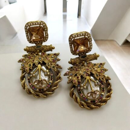 Gold earrings with colorful gemstones, pearls, and leaf design accents.