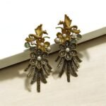 Gold earrings with a bird and flower design, decorated with pearls and crystals.