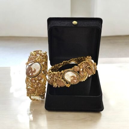 Gold-plated bracelets with pearls, rose gold accents, and intricate crystal details.